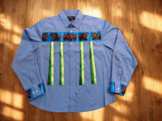 Blue shirt with decorative elements on a wooden surface